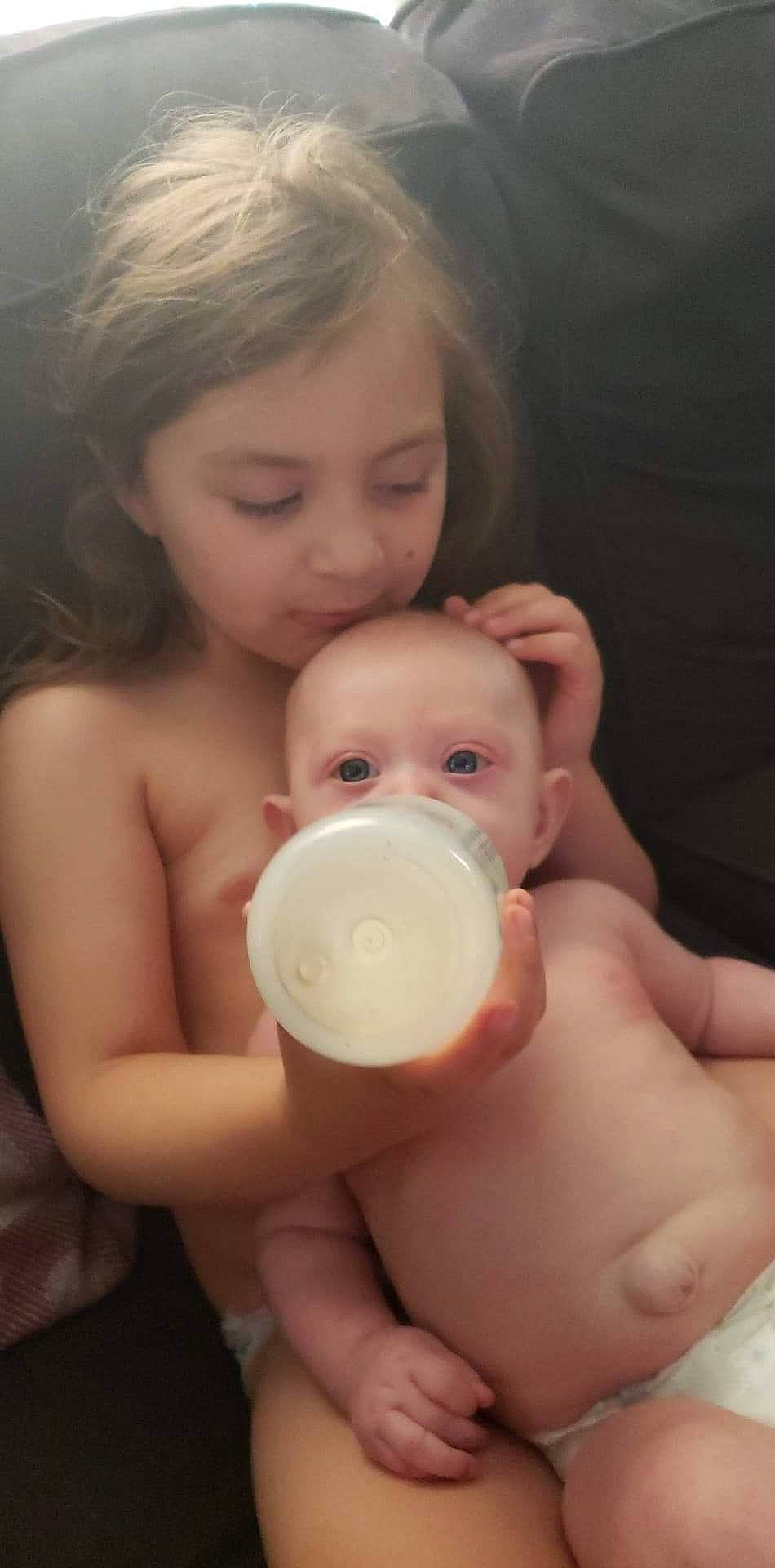 April is registered to the contest to win money with this photo: baby, baby_bottle, baby_products, bottle, child, drinkware, hand, infant_formula, nose, person, product, skin, tableware, toddler