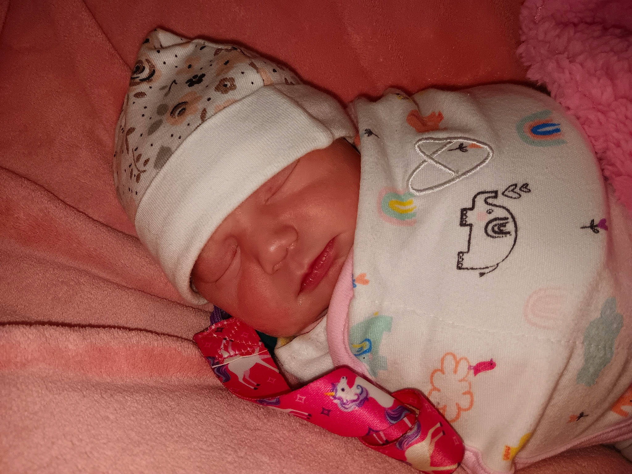 Ariel is registered to the contest to win money with this photo: baby, baby_products, baby_sleeping, baby_toddler_clothing, bedtime, carmine, cheek, child, comfort, flesh, hand, head, headwear, linens, nap, pattern, person, pink, skin, sleeve