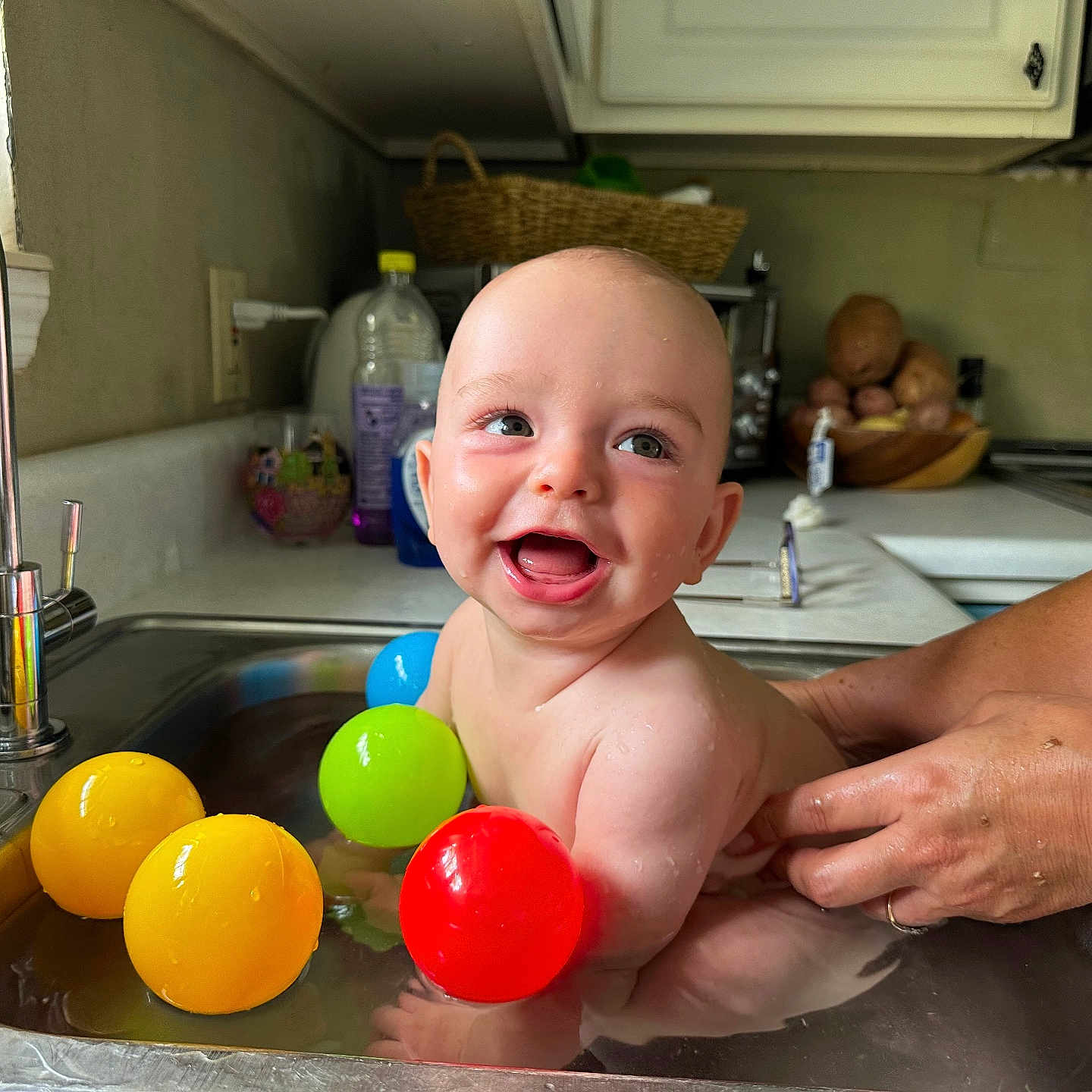 Kaine is registered to the contest to win money with this photo: accessories, baby, babylaughing, bathing, bathtub, bodypart, face, hand, happy, head, indoors, jewelry, pen, person, photography, portrait, ring, sink, sinkfaucet, tub