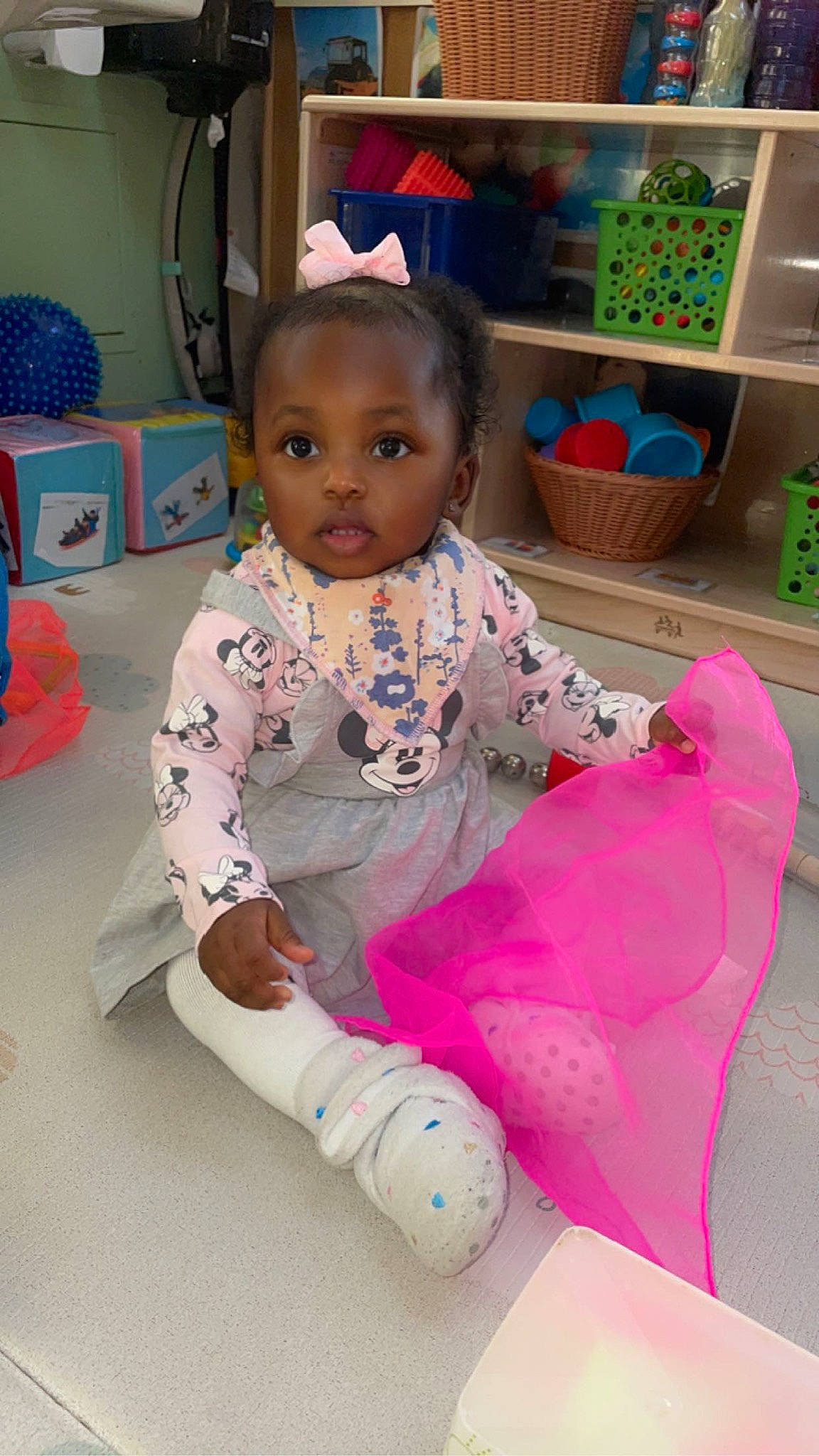 Kiyah is registered to the contest to win money with this photo: baby, baby_toddler_clothing, cheek, child, face, flooring, fun, happy, head, leisure, mammal, person, pink, play, room, sitting, skin, sleeve, sock, textile