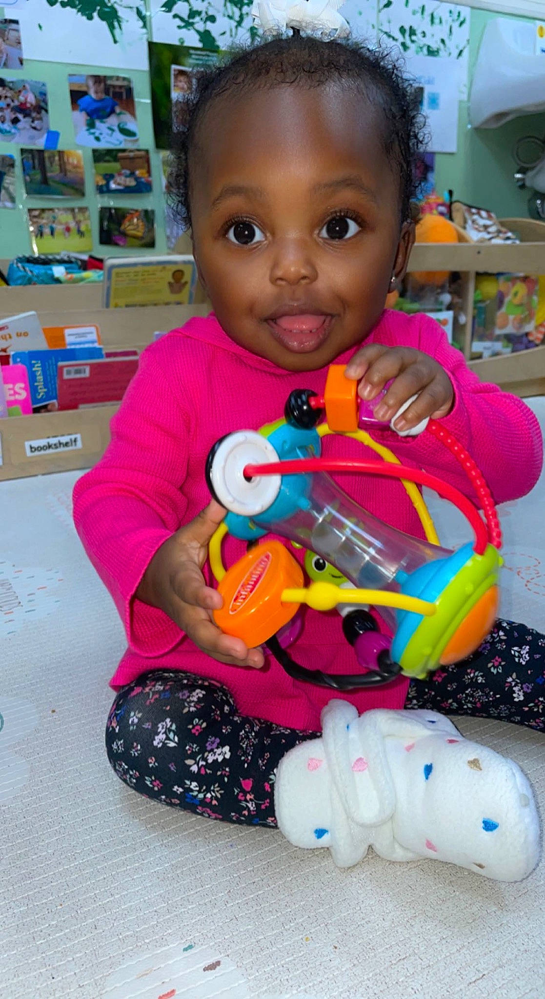 Kiyah joined the competition — help win amazing prizes! baby, baby_products, baby_toys, blurred, cheek, child, event, eye, fun, happy, head, person, pink, plastic, product, shelf, sitting, skin, smile, toddler