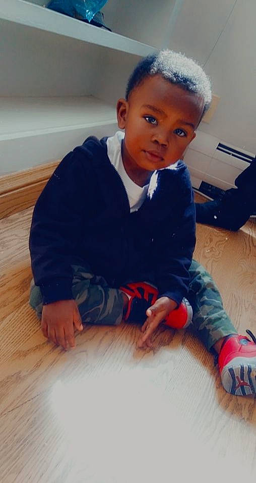 He'Zekiah joined the competition — help win amazing prizes! baby_toddler_clothing, child, collar, elbow, electric_blue, face, floor, flooring, hairstyle, hardwood, head, person, sitting, skin, sleeve, t_shirt, thumb, toddler, wood, wood_flooring