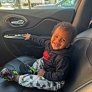 Jiayze joined the competition — help win amazing prizes! toddler, child, smiling, car_seat, black_hoodie, nike_logo, dinosaur_pants, colorful_shoes, car_interior, door_handle, window, daylight, happy, curly_hair, leather_seat, seatbelt, parked_car, outside_view, hand, portrait