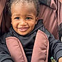 Jiayze joined the competition — help win amazing prizes! toddler, child, smiling, curly_hair, stroller, brown, black_clothing, happy, baby, cute, portrait, infant, seat_belt, hand, face, person, outdoor, closeup, young, playful