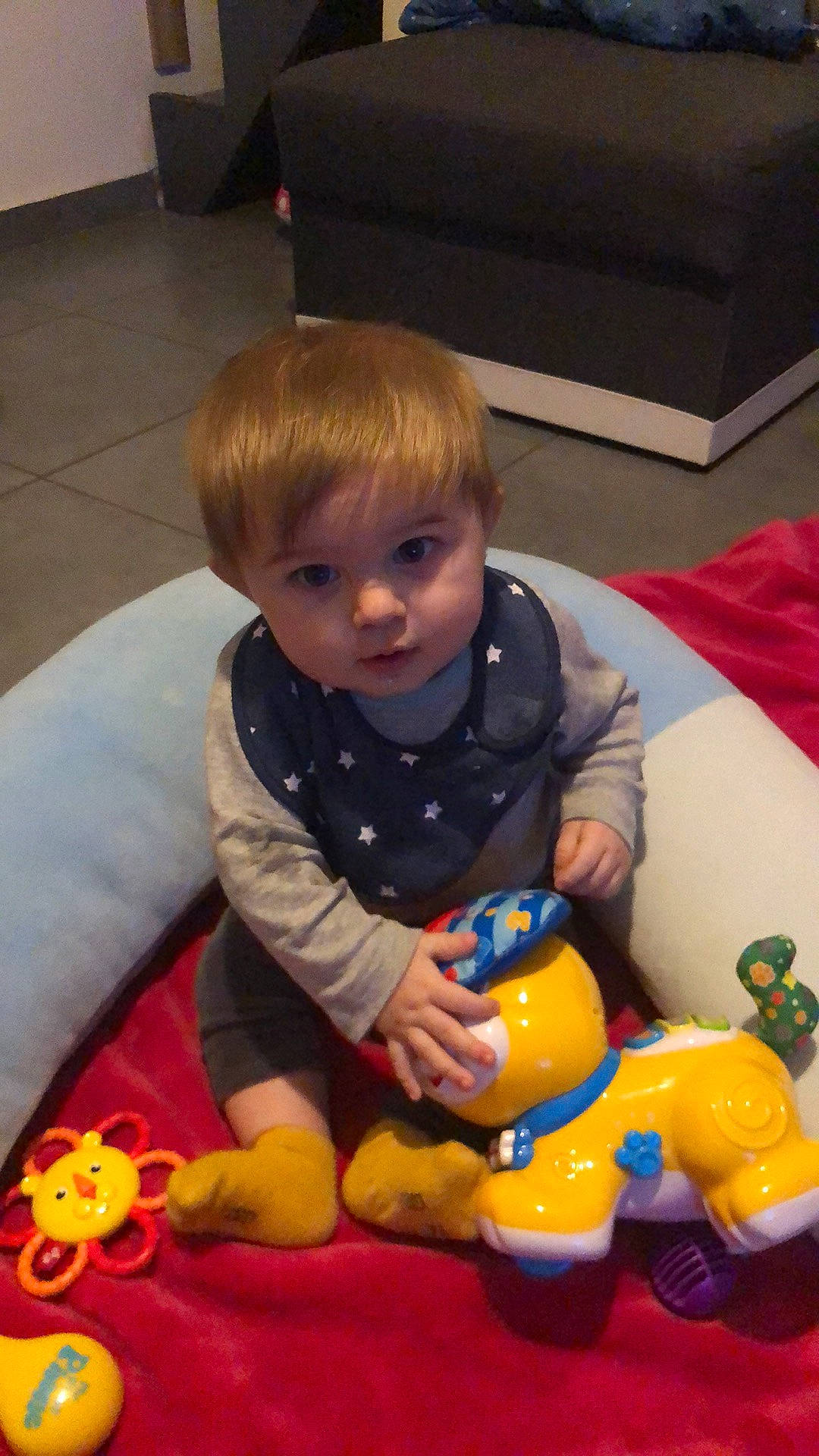 Joseph participe au concours pour gagner de l'argent avec cette photo : baby, baby_playing_with_toys, baby_products, baby_toys, cheek, child, floor, flooring, fun, head, person, play, recreation, room, sitting, skin, stuffed_toy, toddler, toy, toy_vehicle