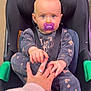 Jade a rejoint le concours — aidez-le/la à gagner de superbes lots ! baby, pacifier, car_seat, infant, hand, adult_hand, clothing, purple, seatbelt, toddler, cute, child, person, indoor, expression, holding, grip, patterned_clothing, comfort, bonding