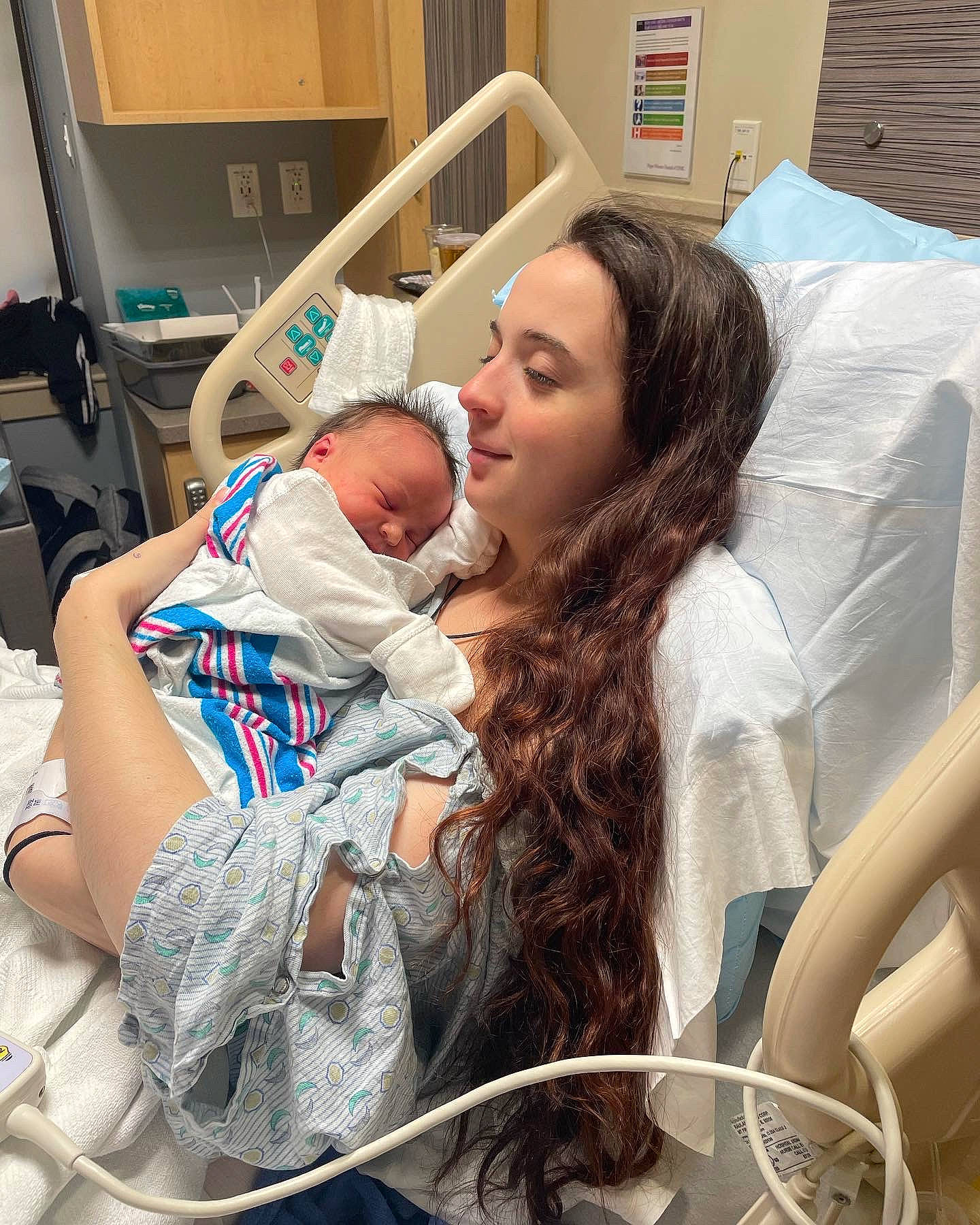 Ellie is registered to the contest to win money with this photo: baby, baby_products, child, comfort, event, happy, health_care, hospital, hospital_bed, hospital_gown, joy, medical, medical_equipment, medical_procedure, mouth, patient, person, service, skin, smile