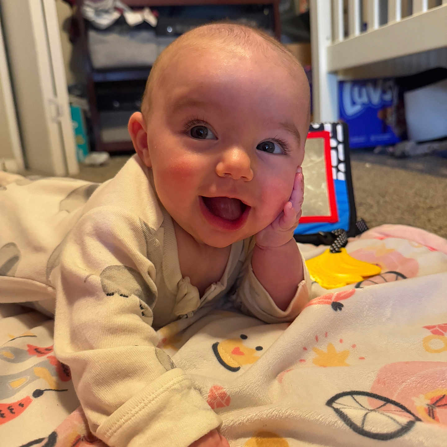 Olivia is registered to the contest to win money with this photo: baby, bed, bedroom, blanket, bodypart, crib, face, finger, furniture, hand, happy, head, indoors, infantbed, laughing, person, photography, portrait, quilt, smile