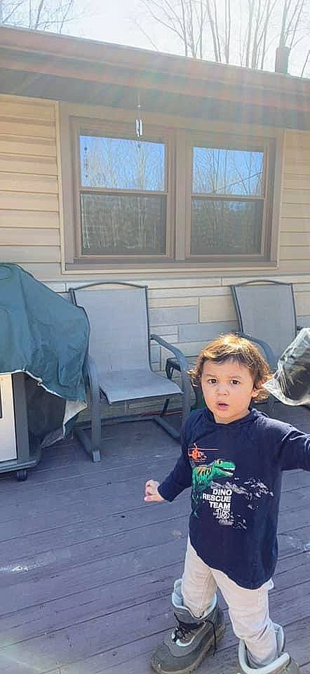Jonah is registered to the contest to win money with this photo: chair, child, event, flooring, fun, hardwood, leaf, leisure, living_room, person, roof, room, siding, sitting, sleeve, t_shirt, toddler, vacation, window, wood