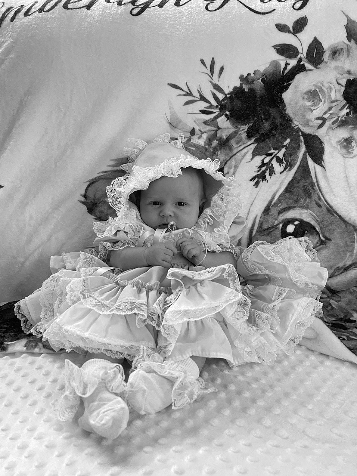 Emberlyn is registered to the contest to win money with this photo: baby, baby_products, baby_toddler_clothing, black_and_white, child, dress, event, fictional_character, font, happy, headpiece, monochrome, monochrome_photography, person, plant, room, stock_photography, style, toddler, toy