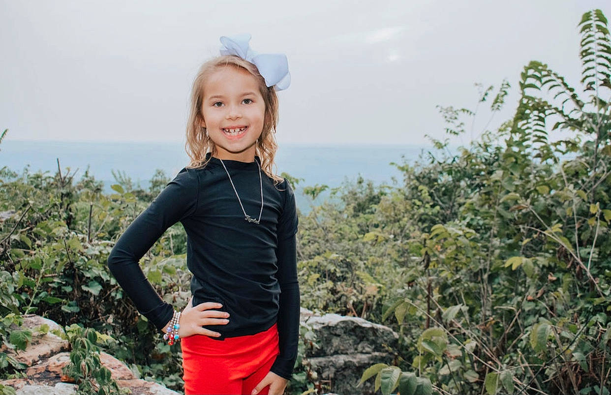 Kynlee joined the competition — help win amazing prizes! adventure, blond, child, fun, happy, joy, mountain, outerwear, people, person, personal_protective_equipment, photography, plant, plant_community, recreation, shoulder, smile, t_shirt, tree, vacation