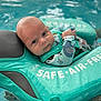 baby, child, pool, water, floatation_device, swimming, infant, face, blue_eyes, wet, splash, aqua, sleepsuit, closeup, summer, safety, water_safety, expression, outdoor, swim
