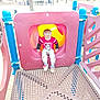 Sebastian is registered to the contest to win money with this photo: child, playground, slide, red_shirt, pants, outdoor, park, play_equipment, yellow_slide, blue_poles, plastic, daylight, trees, bench, metal_platform, young_child, active, fun, casual_clothing, play