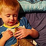 Sebastian is registered to the contest to win money with this photo: child, boy, bearded_dragon, lizard, reptile, bed, pillow, cartoon_character, blue_shirt, yellow_collar, hands, skin, hair, indoor, close_up, animal, pet, curiosity, gentle, resting
