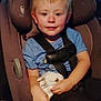 child, car_seat, bunny, animal, pet, blue_shirt, seatbelt, vehicle_interior, young_child, smiling, holding, cute, comfort, safety, portrait, baby, car, child_safety, animal_pet, innocence