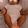 Journey is registered to the contest to win money with this photo: baby, infant, sunglasses, reflective_glasses, white_onesie, blanket, soft_texture, feet, hands, lying_down, indoors, cute, child, portrait, fashion, relaxed, cozy, skin, expressionless, closeup