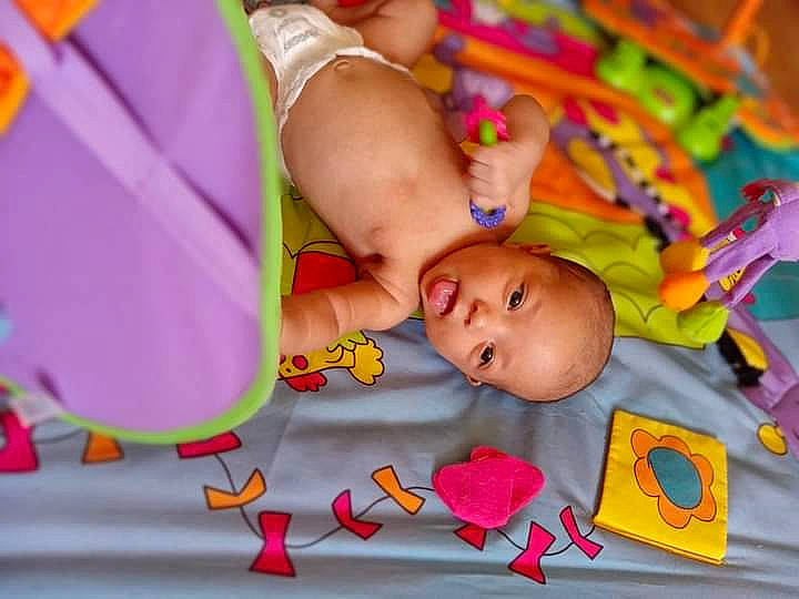 Jada is registered to the contest to win money with this photo: baby, baby_products, baby_toddler_clothing, baby_toys, bedtime, cheek, child, comfort, event, fun, happy, leisure, linens, pattern, person, play, room, textile, toddler, toy