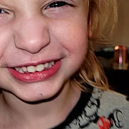 Alijah is registered to the contest to win money with this photo: child, smiling, close_up, face, blond_hair, mickey_mouse, clothing, playful, portrait, indoors, happy, young, person, casual, cute, sweater, expression, fun, childhood, joy