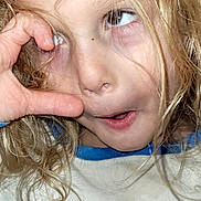 Axel joined the competition — help win amazing prizes! child, blonde_hair, funny_face, expression, hand_gesture, shirt, text_on_clothing, close_up, portrait, playful, mischievous, indoor, person, youth, casual_clothing, face, eye, hair, skin, childhood