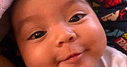 Selena joined the competition — help win amazing prizes! baby, smiling, face, infant, blanket, cute, chubby_cheeks, expression, close_up, indoors, person, superhero_fabric, colorful, soft_texture, head, human, emojis, adorable, happy, portrait
