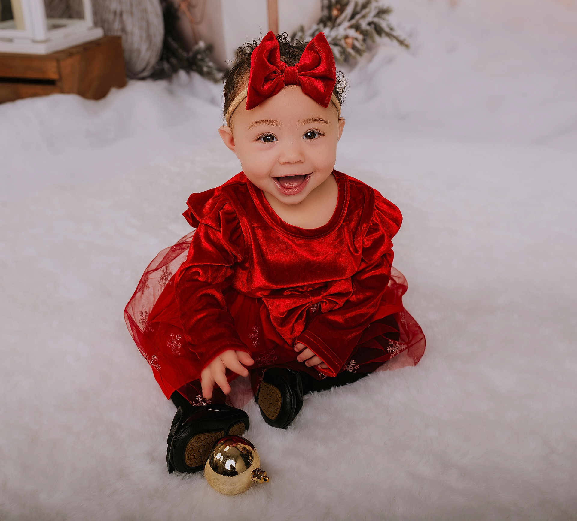 Lovelyn is registered to the contest to win money with this photo: baby, child, red_dress, headband, bow, smiling, holiday, christmas_ornament, festive, fluffy_surface, black_shoes, indoor, cute, portrait, happy, toddler, celebration, seasonal, decor, sitting
