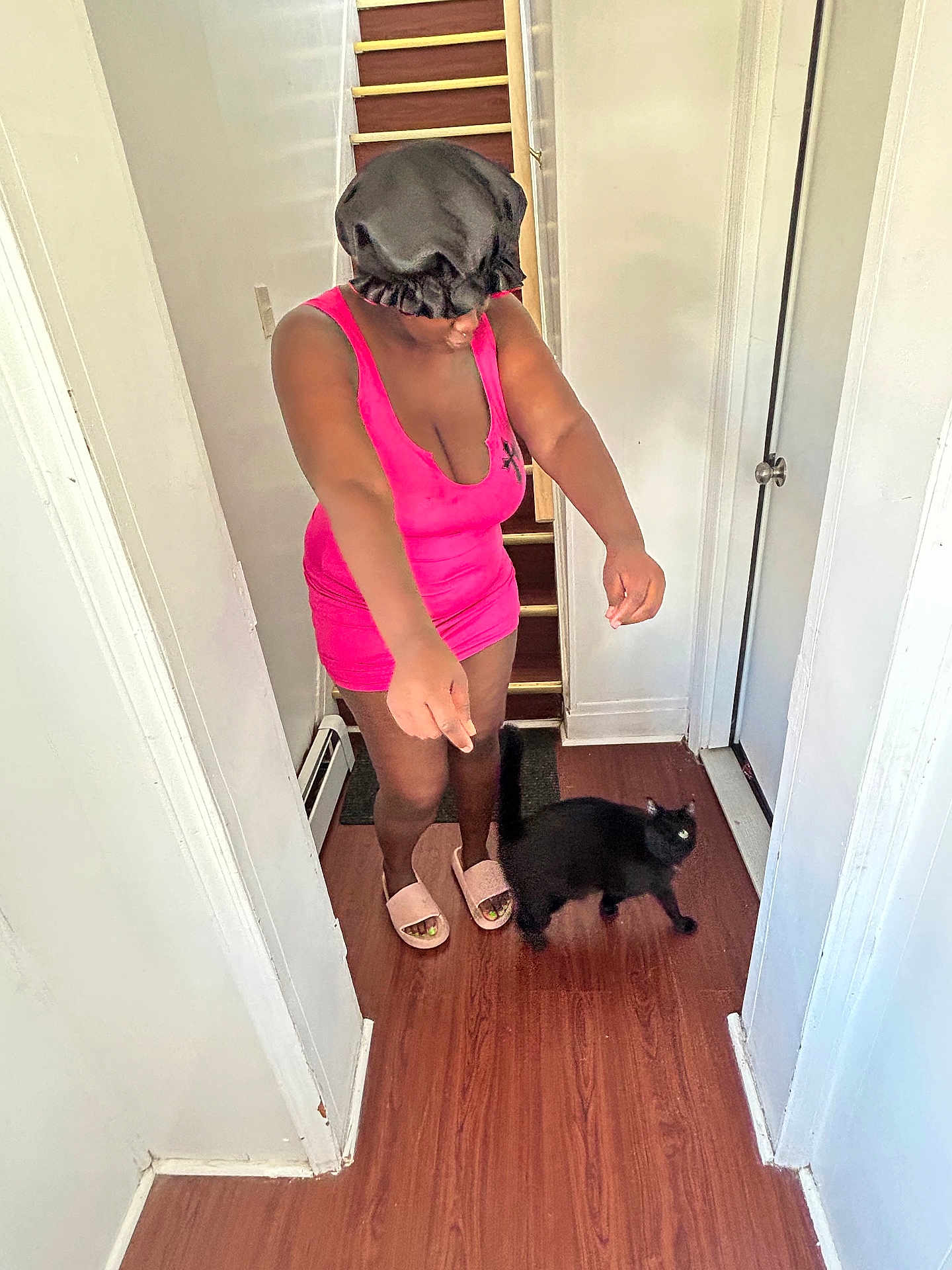 Odem joined the competition — help win amazing prizes! animal, black_cat, bonnet, casual, cat, curious_cat, door, flooring, hallway, home, indoor, interaction, person, pet, pink_dress, playful, slippers, standing, white_wall, wooden_floor