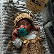 Jashai joined the competition — help win amazing prizes! newborn, baby, pacifier, knitted_hat, bear_ears, blanket, sleeping, cozy, bassinet, infant, cute, soft_texture, white_clothing, bracelet, tag, indoors, resting, peaceful, hand, portrait