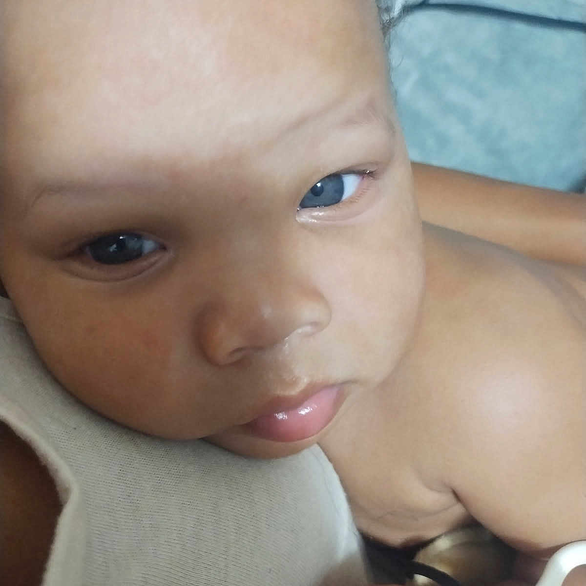 Kdyn is registered to the contest to win money with this photo: baby, blue_eyes, child, close_up, comfort, cute, expression, fabric, face, hand, holding, indoors, infant, light, pacifier, portrait, resting, skin, soft, young