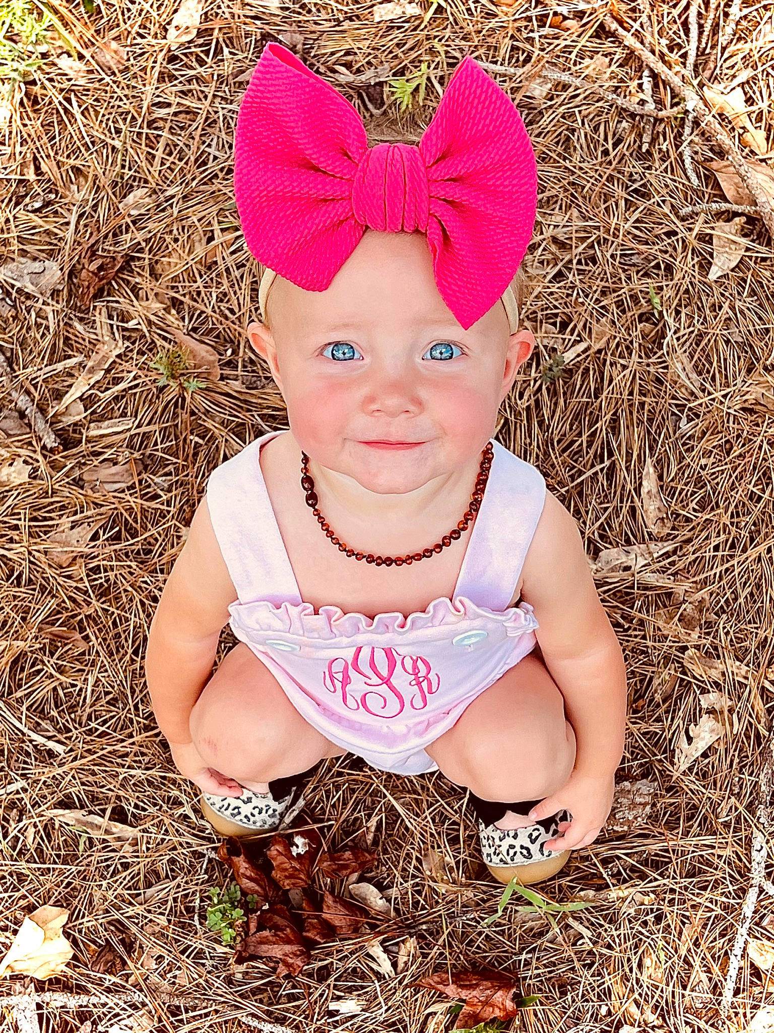 Arllie is registered to the contest to win money with this photo: baby, baby_toddler_clothing, child, eye, face, fashion_accessory, fun, grass, grass_family, hair_accessory, happy, head, headband, headpiece, headwear, joy, magenta, pattern, people_in_nature, person