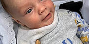 Theo joined the competition — help win amazing prizes! baby, infant, child, blue_eyes, smile, blanket, lace, clothing, pacifier_clip, beads, wooden_beads, grey_outfit, patterned_clothes, closeup, portrait, cute, face, baby_accessory, soft_texture, happy