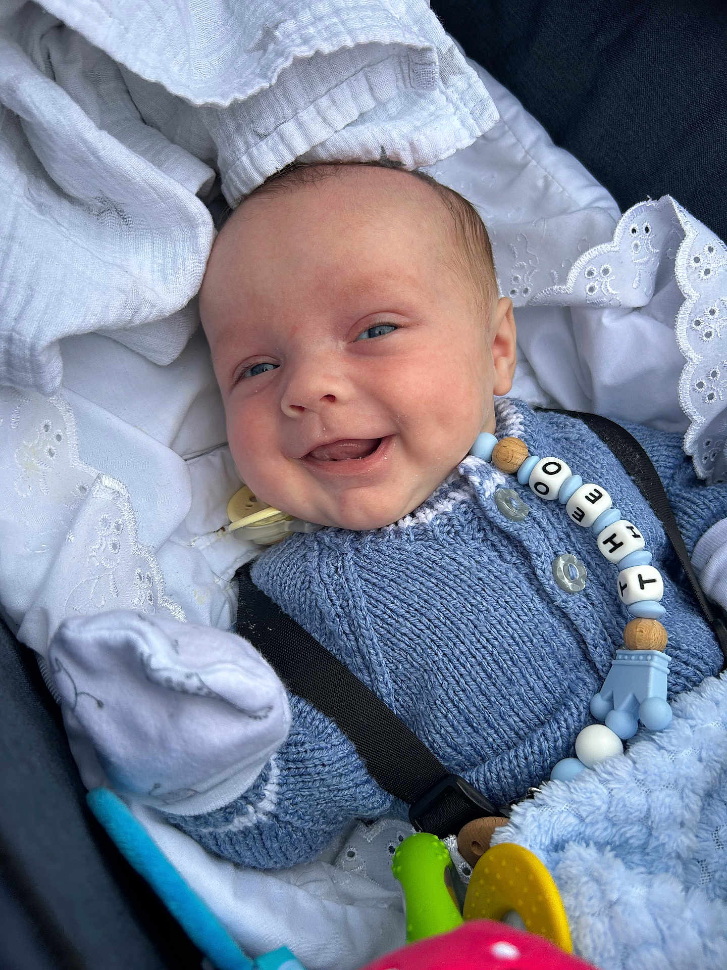 Theo joined the competition — help win amazing prizes! baby, smiling, blue_sweater, blanket, toy, infant, cute, happy, face, closeup, indoor, comfort, child, knitwear, accessory, pacifier_clip, soft_texture, portrait, baby_clothes, newborn