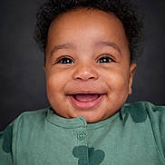 Elijah -Alejandro joined the competition — help win amazing prizes! baby, infant, child, smile, teeth, eyes, curly_hair, dimple, onesie, green_clothing, portrait, closeup, studio_background, happy, cheek, face, button, skin, front_lighting, cute