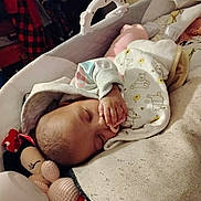 Jordyn is registered to the contest to win money with this photo: baby, infant, sleeping, bassinet, pacifier, blanket, stuffed_toy, minnie_mouse_doll, hand, cozy, asleep, nursery, bedding, onesie, winnie_the_pooh_pattern, closeup, newborn, plush_toy, soft_light, home_interior