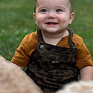 Barrett joined the competition — help win amazing prizes! baby, child, smiling, face, eyes, teeth, overalls, shirt, outdoor, grass, greenery, happy, portrait, sitting, cute, infant, nature, person, young, cute_face