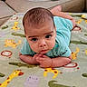 Noah is registered to the contest to win money with this photo: baby, infant, child, onesie, blanket, animal_print, giraffe, tiger, crocodile, hippopotamus, face, hands, floor, couch, indoor, cute, curious, portrait, lying_down, expression