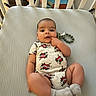 Noah joined the competition — help win amazing prizes! baby, crib, onesie, socks, pacifier, infant, child, cute, lying_down, expression, hand, indoor, furniture, mattress, face, person, playful, baby_clothing, baby_toy, childhood