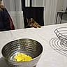 animal, bowl, cat, chair, chips, curious, curtains, dining_room, feline, food, fruit_basket, home, indoor, metal, pet, portrait, tabby_cat, table, tablecloth, window