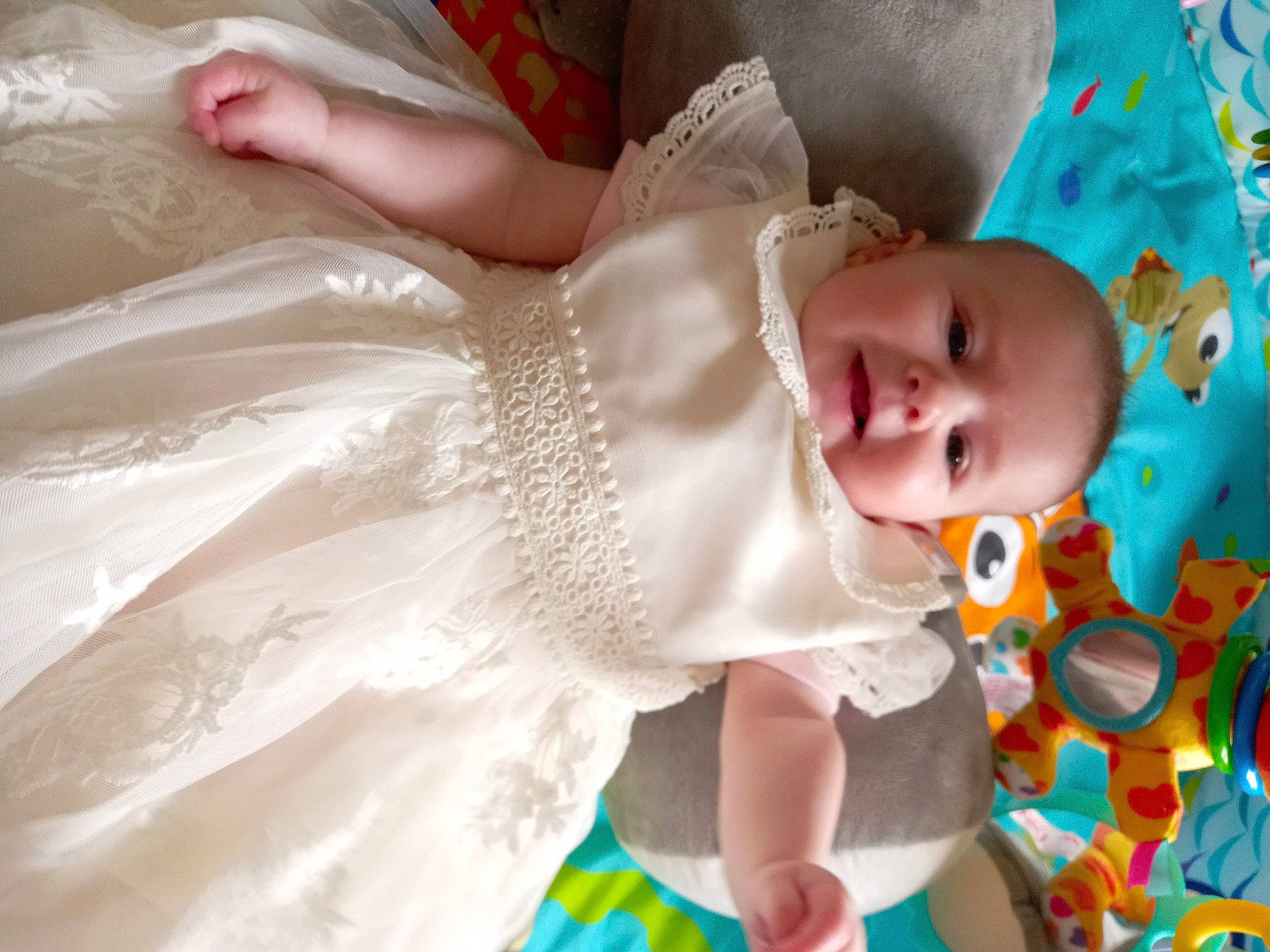 Eloise is registered to the contest to win money with this photo: baby, baby_products, baby_toddler_clothing, bridal_accessory, child, day_dress, dress, embellishment, event, fashion_accessory, fun, happy, head, headpiece, iris, pattern, peach, person, room, skin