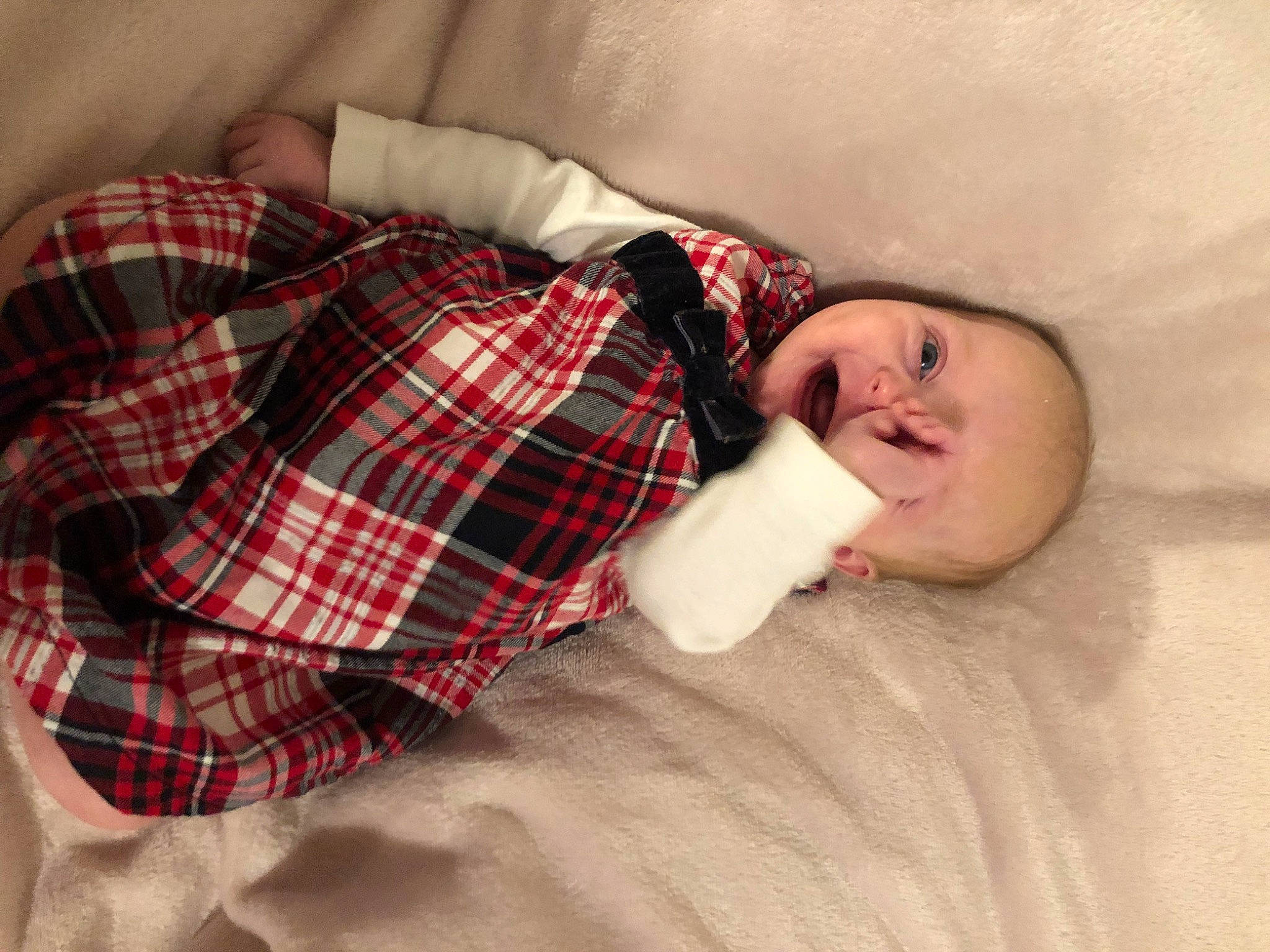 Daisy is registered to the contest to win money with this photo: baby_toddler_clothing, bedding, child, comfort, couch, eyelash, flesh, flooring, hardwood, linens, mammal, pattern, person, plaid, room, sitting, sleeve, tartan, textile, toddler