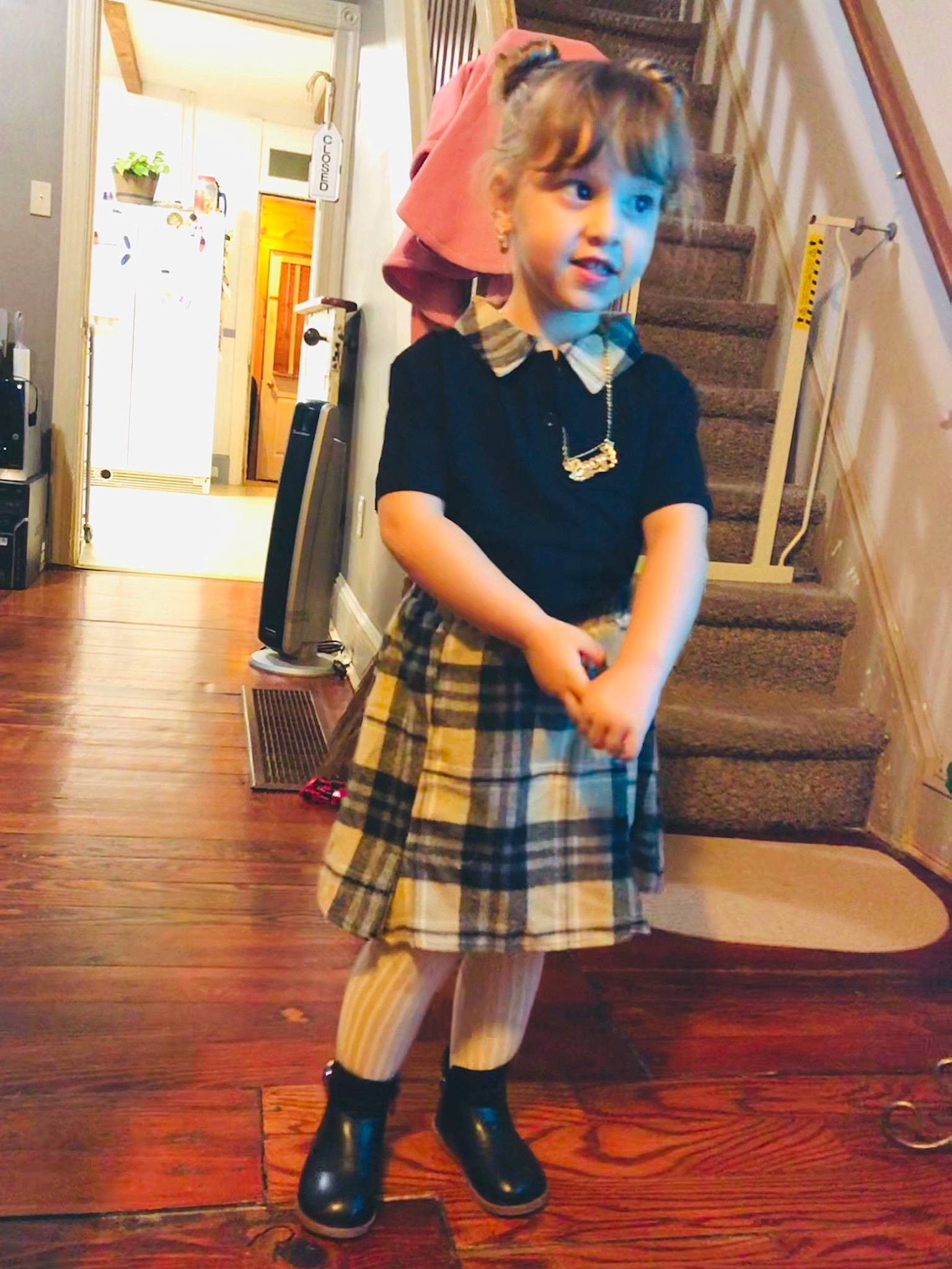Lucy is registered to the contest to win money with this photo: child, costume, dress, electric_blue, event, fashion_design, flooring, fun, hat, human_leg, knee, pattern, person, plaid, school_uniform, sleeve, sock, tartan, toddler, uniform