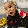 baby, infant, party_hat, birthday, celebration, confetti, balloon, number_8, bib, crawling, happy, smiling, face, child, indoors, colorful, clothing, festive, portrait, closeup