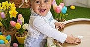 Dallas joined the competition — help win amazing prizes! toddler, child, smiling, standing, overalls, cap, easter_eggs, plush_bunny, basket, flowers, tulips, green_carpet, indoor, happy, cute, spring, decorations, white_shoes, person, holiday