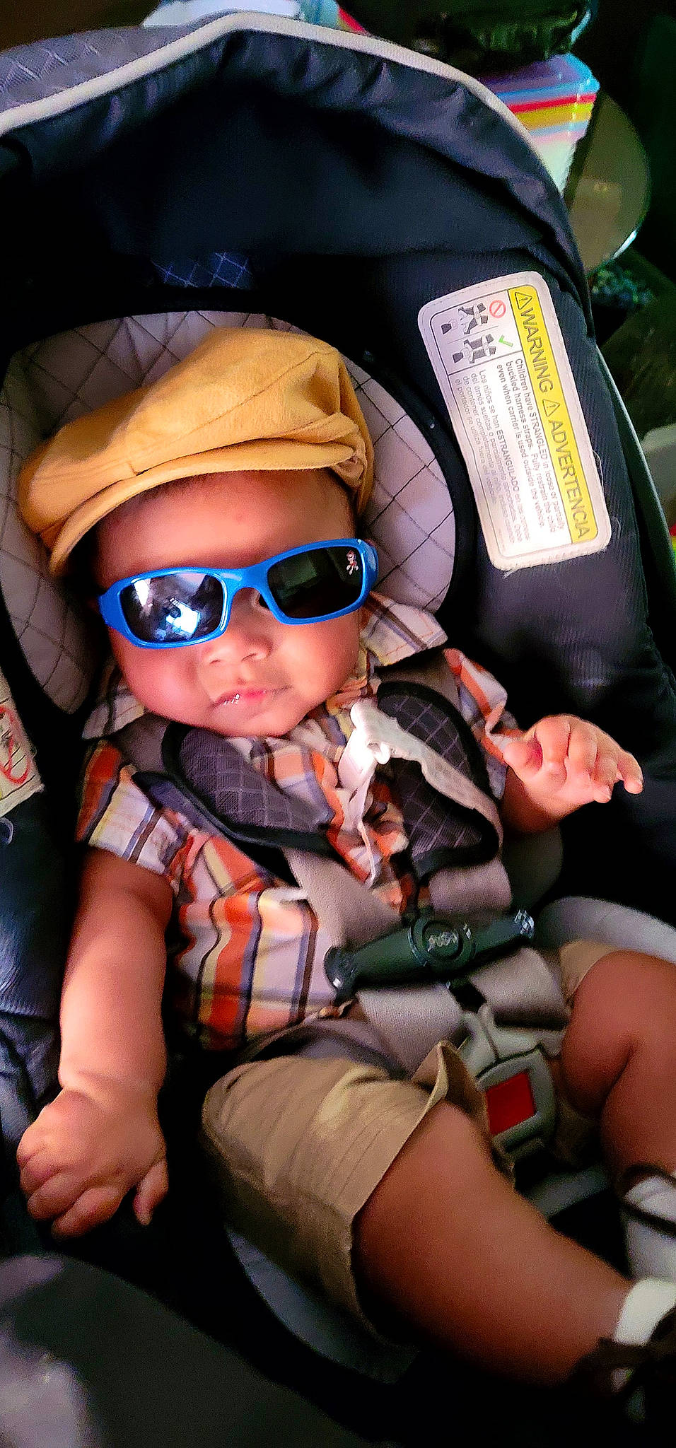 Derek joined the competition — help win amazing prizes! baby_carriage, baby_toddler_clothing, baseball_cap, cap, car_seat, child, comfort, cool, electric_blue, eyewear, fun, glasses, goggles, headwear, helmet, person, personal_protective_equipment, plaid, seat_belt, sunglasses