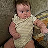 baby, infant, child, couch, onesie, striped_clothing, fist, hair, wide_eyes, expression, indoor, furniture, cute, plump, sitting, person, skin, face, arm, leg