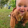 baby, child, smiling, crawling, grass, outdoor, park, jacket, blue_eyes, happy, face, person, nature, greenery, hoodie, infant, cute, young_child, daylight, casual