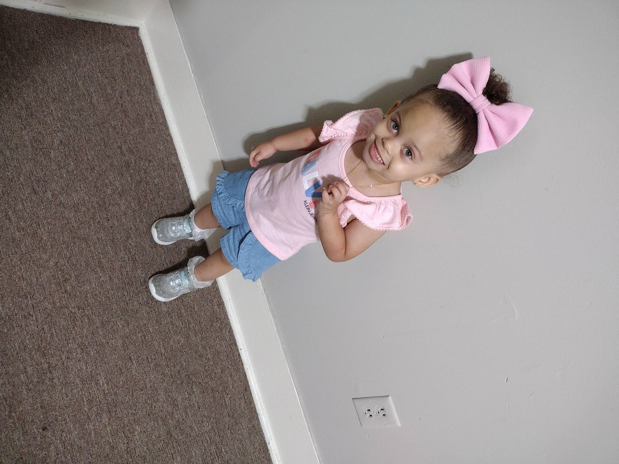 Winter is registered to the contest to win money with this photo: baby, baby_products, baby_toddler_clothing, ceiling, child, elbow, flooring, fun, hardwood, hat, human_leg, joy, magenta, person, room, sleeve, t_shirt, thigh, toddler, wood