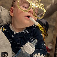 Jameson joined the competition — help win amazing prizes! baby, sleeping, glasses, happy_new_year, party_blower, bottle, infant, face, hand, clothing, celebration, holiday, festive, indoors, cute, child, person, portrait, cozy, nap