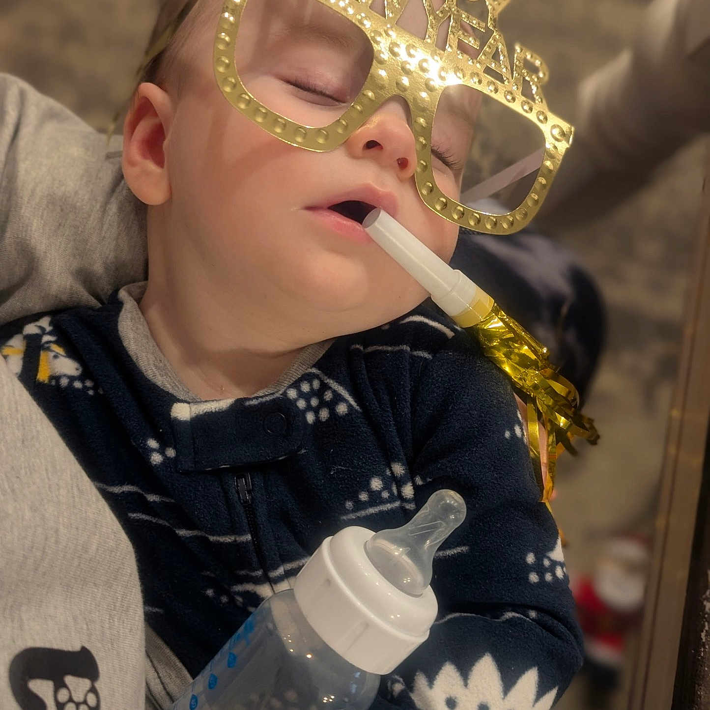 Jameson joined the competition — help win amazing prizes! baby, bottle, celebration, child, clothing, cozy, cute, face, festive, glasses, hand, happy_new_year, holiday, indoors, infant, nap, party_blower, person, portrait, sleeping