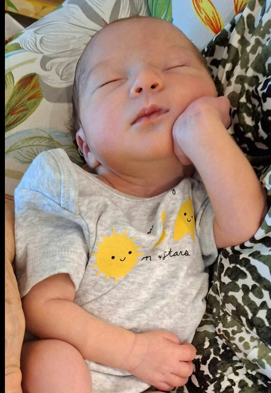 Kaylee is registered to the contest to win money with this photo: baby, sleeping, infant, onesie, clothing, hand, face, peaceful, cute, newborn, pattern, fabric, resting, child, portrait, soft, skin, indoors, comfort, relaxation
