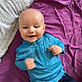 Louka participe au concours pour gagner de l'argent avec cette photo : baby, smiling, blue_clothing, bald_head, pillow, blanket, lying_down, infant, happy, child, face, person, indoor, cute, young, portrait, sleeve, fabric, zipper, fingertips
